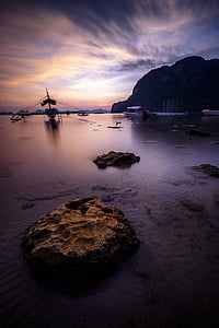 two boats on body of water during golden hour thumbnail