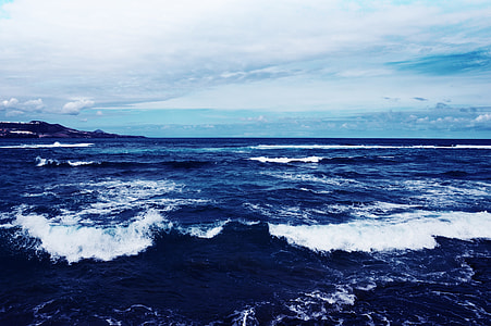 sea with waves under white skies during daytime thumbnail