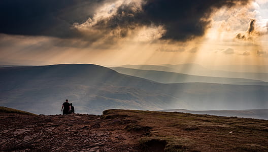 two person walking along mountain during daytime thumbnail