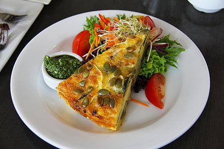 sliced pie with tomatoes on white plate thumbnail