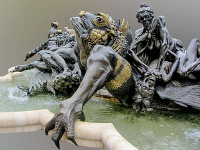 photo of black reptile with skeleton statue fountain thumbnail