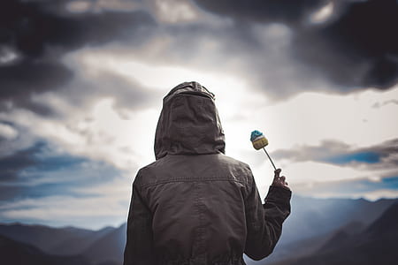 person raising stick outdoors thumbnail
