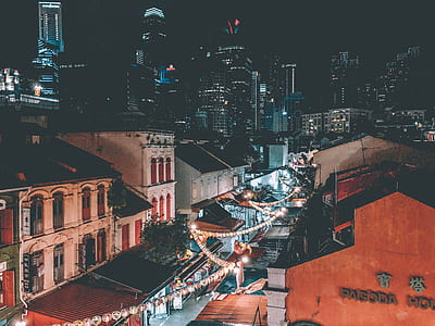 road in front of a buildings with lights turned on during nighttime thumbnail