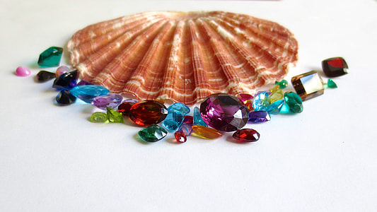 brown clam shell surrounded with assorted multicolored gemstones thumbnail