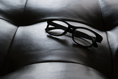 black framed eyeglasses on couch thumbnail