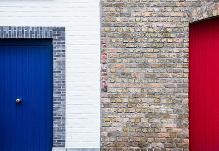 blue door on white wall and red door on brick wall thumbnail