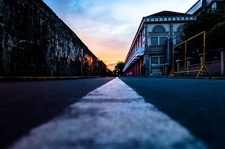 shallow focus photo of road between buildings thumbnail