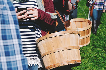 people holding brown wooden buckets thumbnail