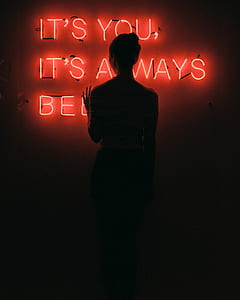 woman touching red neon signage thumbnail