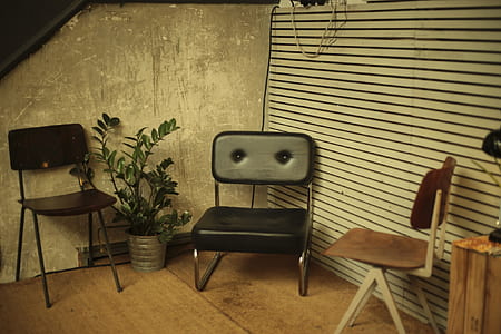 three assorted-color chairs beside walls thumbnail