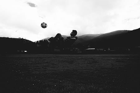 person kicking soccer ball photo thumbnail