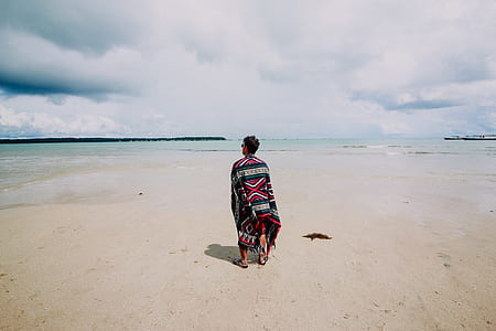 man standing in front on beach during daytime thumbnail