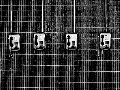 four silver telephones on wall thumbnail