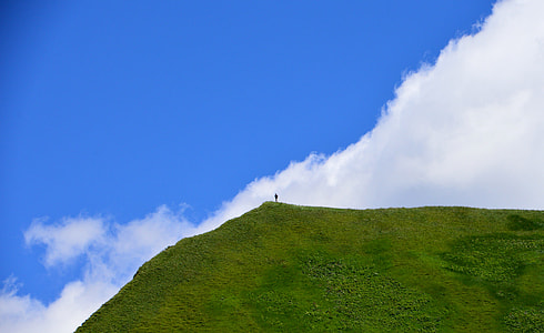 person standing on mountain cliff thumbnail