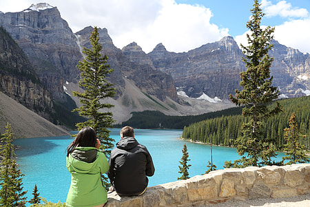 man and woman sitting on hill thumbnail