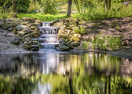 river beside rocks and trees during daytime thumbnail