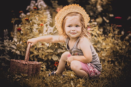 girl wearing gray tank top and pink floral shorts outfit holding brown wicker basket thumbnail