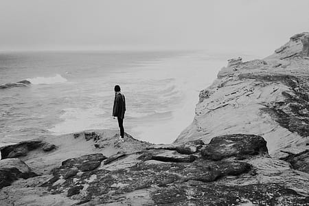 woman in black jacket standing on cliff thumbnail