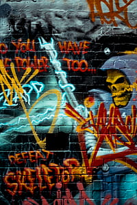 skull painting in brick wall thumbnail