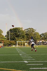 Man Playing Football Near Green Leaf Trees thumbnail