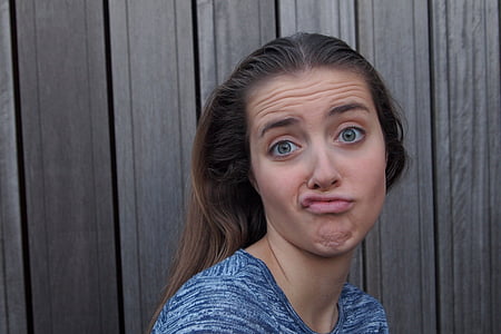 woman in blue and white top doing make face thumbnail