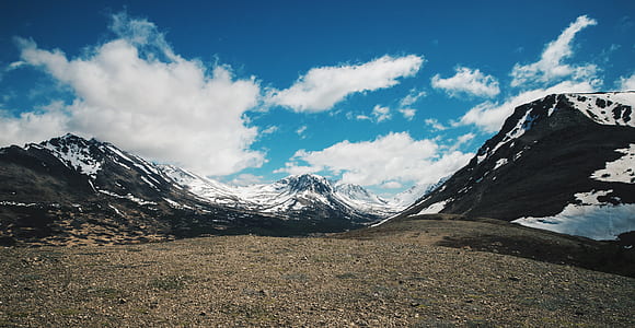 snow-covered mountains under cloudy sky during daytime thumbnail