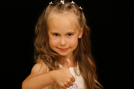 girl wearing white tank top raising her thumb while taking photo thumbnail