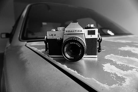 Gray Scale Photography of Silver and Black Praktica Dslr Camera thumbnail