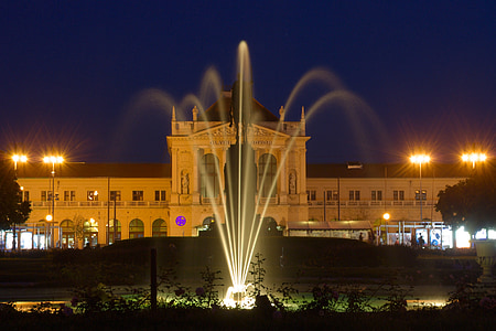 outdoor fountain turned on at nighttime thumbnail