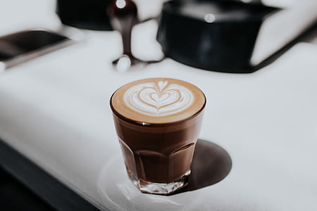 macro photography of latte in clear beverage glass thumbnail