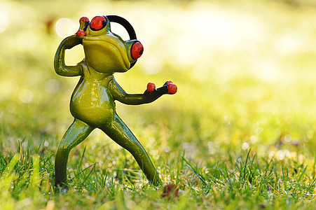 green frog figurine on green grass at daytime thumbnail