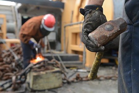 person holds brown and yellow hammer thumbnail