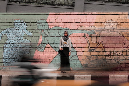 woman standing near graffiti wall thumbnail