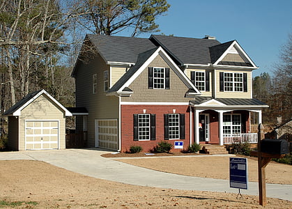 house surrounded by trees under blue sky thumbnail