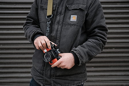 person holding red and black MILC thumbnail