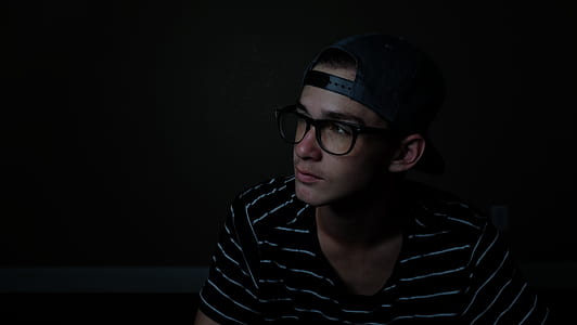 man wearing black and white striped shirt and black cap thumbnail