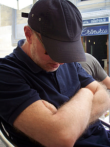 man with his arms crossed sitting on chair thumbnail