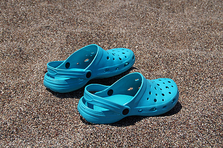teal Crocs Classic clogs on brown surface thumbnail