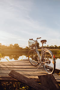 Bicycle with basket on the pier in bright sunset light thumbnail