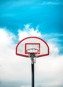 basketball hoop and ring under white and blue sunny cloudy sky thumbnail