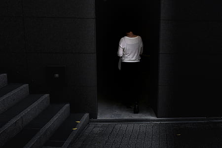 woman in white top walking through the dark thumbnail