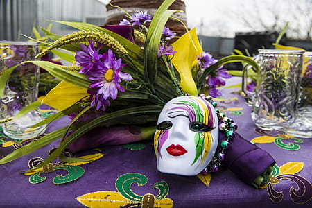 white, pink, and green mask near purple flower thumbnail
