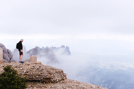 Man standing Landmark marker on the high mountains in Montserrat, Spain thumbnail