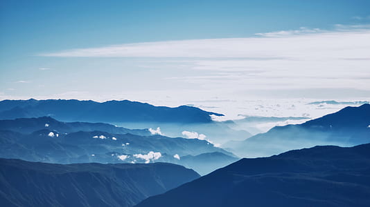 aerial photo of mountains under white clouds and blue sky thumbnail