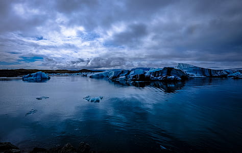 body of water under white clouds thumbnail