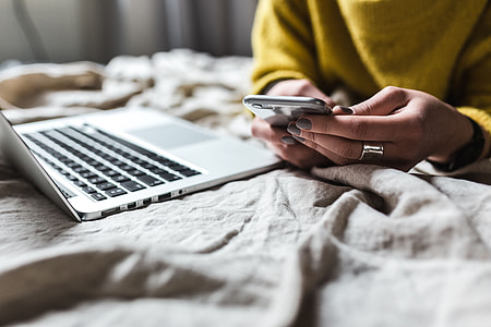 Blond using her laptop at her bedroom thumbnail