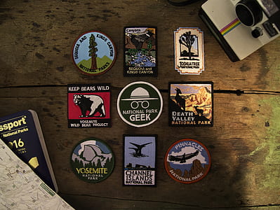 nine assorted badges on table thumbnail