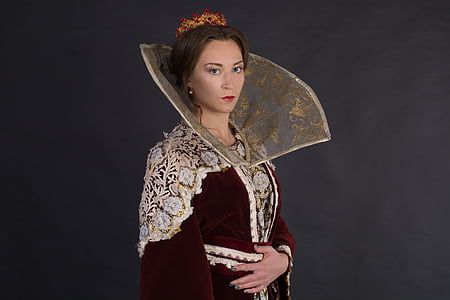 woman in maroon and white bindali dress standing thumbnail
