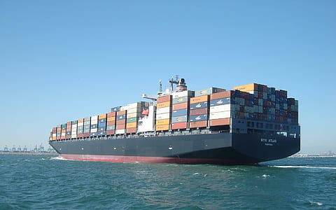 black cargo vessel on sea taken under clear sky during daytime thumbnail