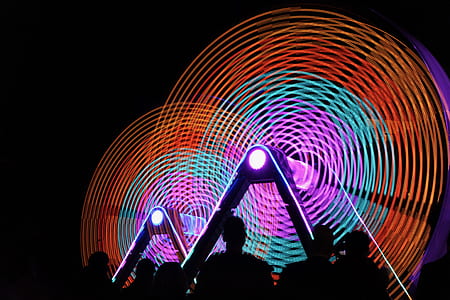 silhouette of people standing while watching multicolored light shows thumbnail
